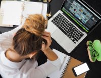 woman sitting in front of macbook